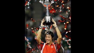 Uplifting: Kei Nishikori of Japan lifts his trophy after his victory against Milos Raonic of Canada in the final at the Japan Open tennis championship in Tokyo. Yuriko Nakao / Reuters