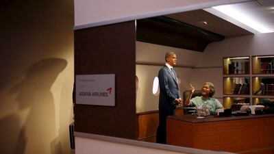 A man poses for photographs on July 30, 2015, with the wax figure of US president Barack Obama at Grevin Wax Museum in Seoul, South Korea. Kim Hong-Ji / Reuters