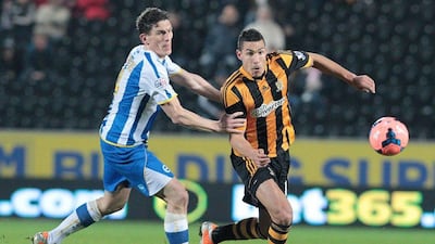 Hull City's English midfielder Jake Livermore, right, vies for the ball against Brighton and Hove Albion's Irish midfielder Keith Andrews during an English FA Cup fifth round replay football match between Hull City FC and Brighton and Hove Albion FC at the KC Stadium, north-east England on February 24, 2014. AFP PHOTO/LINDSEY PARNABY
