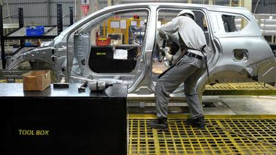 Labourers work at the new Nissan plant in Purwakarta, West Java province. According to Nissan, the inauguration of its newest Nissan manufacturing facility dedicated to the production of Datsun cars for Indonesia, will boost their local production from 100,000 units per year to 250,000 as part of the expansion campaign by the Japanese automotive giant to become a leading brand in the Southeast Asia's biggest economy. Bay Ismoyo / AFP