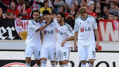 Bayer Leverkusen players celebrate with Son Heung-min, second left, after his goal against Stuttgart on Saturday in the Bundesliga. Bernd Weissbrod / AP / October 19, 2014