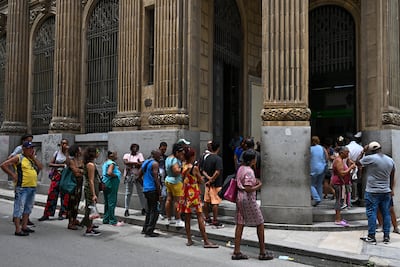 People queue outside a bank in Havana. AFP
