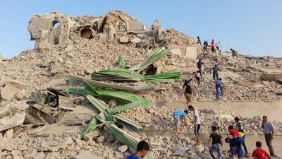 Iraqis inspect the wreckage of the grave of the Nebi Yunus, or prophet Jonah, in Mosul, northern Iraq. EPA
