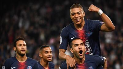 Paris Saint-Germain's Dani Alves carries goalscorer Kylian Mbappe on his back after the French striker scored his third goal in a 3-1 win over Monaco at Parc des Princes in Paris that secured a seventh Ligue 1 title in eight years for PSG. AFP