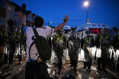 A protestor and riot police close to the location where Henry Nowak died in Southampton. Getty
