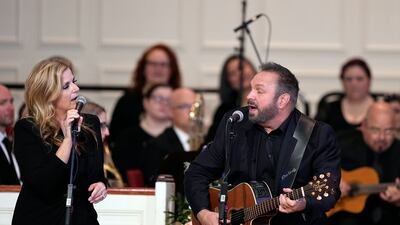 Garth Brooks and Trisha Yearwood perform Imagine at the service. EPA