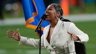 Jazmine Sullivan performs in a cream blazer and bejewelled headpiece. AP