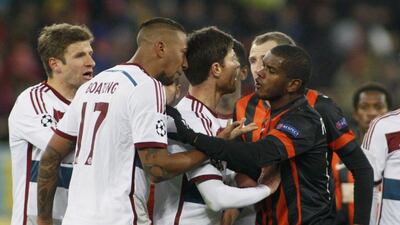 Jerome Boateng, second left, gets involved in a confrontation during Bayern's draw at Shakhtar. Valentyn Ogirenko / Reuters