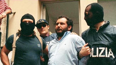 Giovanni Brusca (C) is led off by police following his interrogation in Palermo, Sicily, Italy, 21 May 1996. EPA