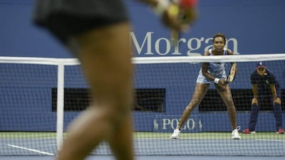 Venus Williams prepares for a serve from sister Serena during their quarter-final match at the US Open on Tuesday. Justin Lane / EPA