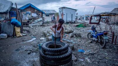A woman draws water from a well in the coastal area renamed by residents “Yolanda Village” on April 19, 2014 in Tacloban, Leyte, Philippines. Chris McGrath / Getty Images