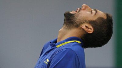 Marin Cilic reacts during his first round loss to Ivo Karlovic at the Shanghai Masters ATP event on Monday. Zhong Zhi / Getty Images / October 6, 2014