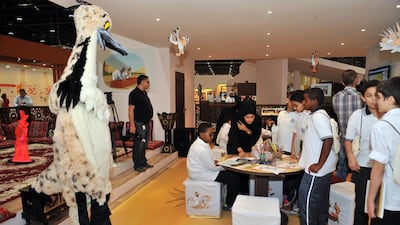 A volunteer dressed as a houbara keeps children entertained. Courtesy Adihex