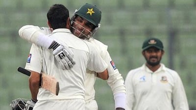 Pakistan's cricket captain Misbah-ul-Haq, second from left, gives teammate Younis Khan a hug after their squad made quick work of Bangladesh to win the Test series 2-0.