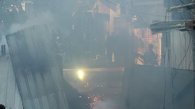Anti-government protesters shoot fireworks during clashes with Iraqi security forces in Baghdad. AP Photo