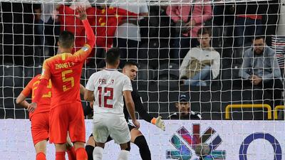 China's defender Yu Dabao scores their third goal against the Philippines. AP Photo/Kamran Jebreili