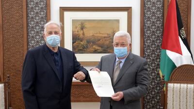 Palestinian President Mahmoud Abbas hands the election decree to the chairman of the Palestinian Central Election Committee Hana Naser in Ramallah in the Israeli-occupied West Bank on January 15, 2021. Palestinian President Office via Reuters