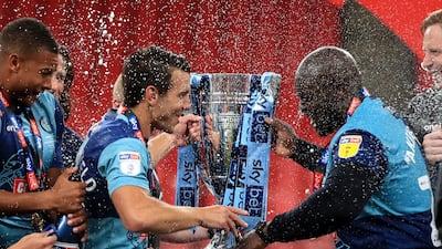 Wycombe Wanderers' Matt Bloomfield (left) and Adebayo Akinfenwa prepare to lift the trophy. PA
