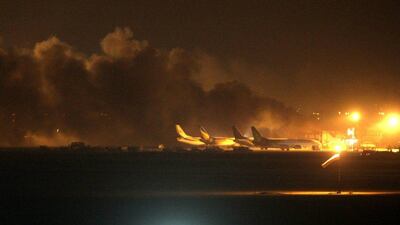 Fire illuminates the sky above the Jinnah International Airport in Karachi where security forces fought off Pakistani Taliban attackers on the night of June 8, 2014, in Pakistan. Gunmen disguised as police guards attacked a terminal with machine guns and a rocket launcher during a five-hour siege that killed at least 37 people. Fareed Khan/AP Photo