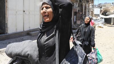 A Palestinian woman flees after an Israeli strike on a house in Gaza city. Reuters