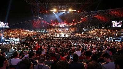 Fans watch the featherweight bout between Jim Alers and Alan Omer at du Arena in Abu Dhabi on April 11, 2014. Pawan Singh / The National