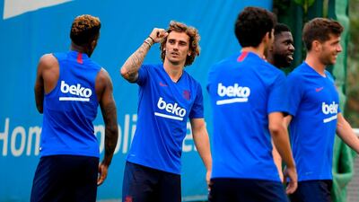 BFrench forward Antoine Griezmann speaks to a Barcelona teammate. AFP