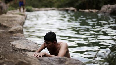 A Yemeni youth cools off in a swimming hole on the outskirts of Sanaa. Hani Mohammed / AP Photo