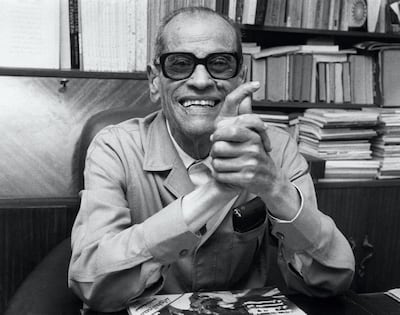 Naguib Mahfouz by his desk in Cairo in 1988, obviously happy about his Nobel Prize for Literature. AFP