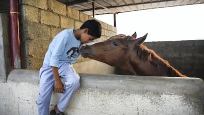 Muatassim Al Maskari, 10, proudly calls his horse his friend. Courtesy of David Ismael