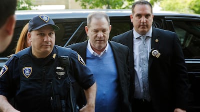 Detective Nicholas DiGaudio, right, escorts Harvey Weinstein into court in New York. AP