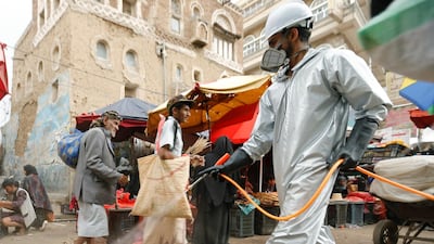 A health worker wearing a protective suit disinfects a market amid concerns of the spread of the coronavirus disease, in Sanaa, Yemen. Reuters
