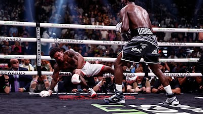 Errol Spence Jr is knocked down by Terence Crawford - one of three for Spence. EPA