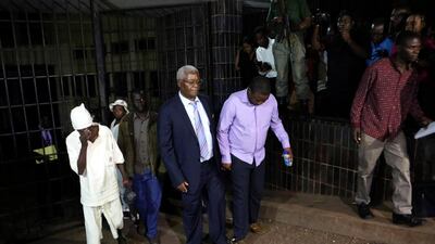 Zimbabwe's former finance minister, Ignatius Chombo, centre left, is led to a prison truck at the magistrates courts in Harare. AP Photo/Tsvangirayi Mukwazhi