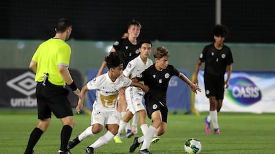 Players in action during the U14 Mina Cup final match between Pumas Unam (white) and Manchester City Football Schools (black) at Jebel Ali Centre of Excellence.