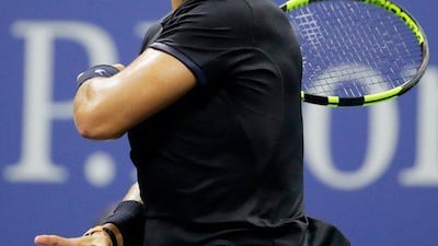 Rafael Nadal returns a shot to Andrey Kuznetsov. Andy Lyons / Getty Images / AFP