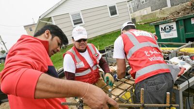 Volunteers including Adel Al Areefi and Hasan Al Ali undertake building work on the home in Sea Bright, New Jersey. The volunteers were coordinated by Takatof, an Emirati organisation that provides humanitarian volunteer opportunities for youth in the UAE.
