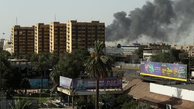 Smoke rises from a storage site in Baghdad, housing ballot boxes from Iraq's May parliamentary election. Thaier Al-Sudani / Reuters
