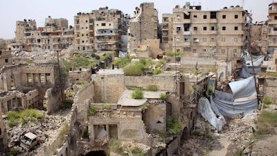 A general view shows blankets hanging across the road for protection from sniper fire in the Hamidiyeh neighbourhood of the northern Syrian city of Aleppo as local popular committee fighters, who support the Syrian government forces, try to defend the traditionally Christian district on the third day of intense battles with ISIS on April 9, 2015. AFP