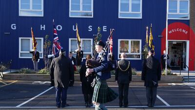A piper plays during a service at Poppyscotland's Lady Haig Poppy Factory in Edinburgh, Scotland. PA