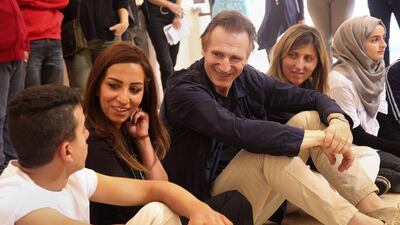 Liam Neeson met Syrian child refugees in Jordan to learn about their struggles in exile. Sam McNeil / AP Photo