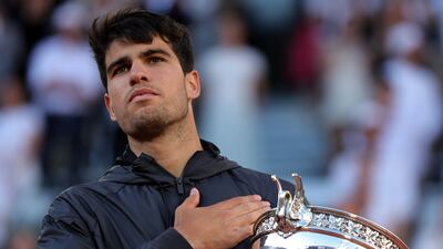 Carlos Alcaraz of Spain poses with the Coupe des Mousquetaires trophy after beating Alexander Zverev of Germany in the French Open final. EPA