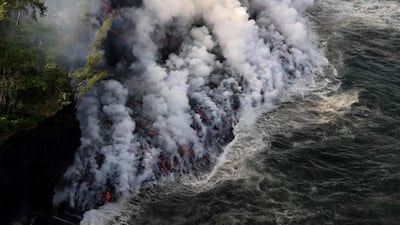 Smoke rises as lava from the Piton de la Fournaise volcano reaches the ocean on the island of Reunion. AFP