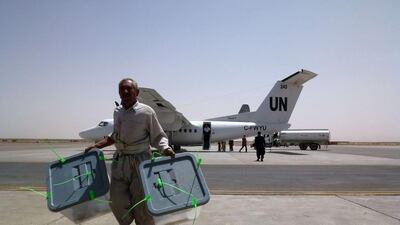 Afghan election commission workers, overseen by Nato-led Italian troops, unload ballot boxes flown in on a UN aircraft from Farah province and to be sent onward to Kabul, at Herat airport on July 24, 2014. Afghanistan is undertaking a massive anti-fraud audit of its recently concluded presidential vote to avert an impasse that threatened to revive ethnic conflict as foreign forces wind down their war against the Taliban. AFP Photo