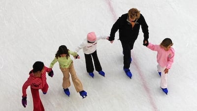 Parents and children alike enjoy the facilities at the Olympic-size ice skating rink at Dubai Mall. Paulo Vecina / The National