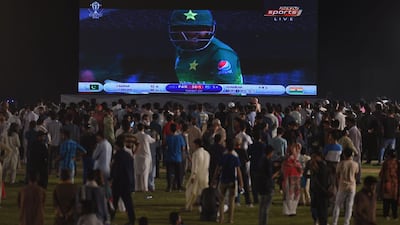 Pakistani youth react as they gather in a park in Islamabad to watch on a big screen. AFP