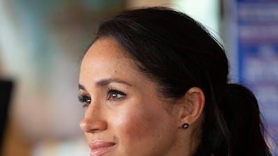 Meghan listens as husband Harry gives a speech in Wellington. AP