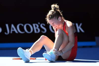 Simona Halep of Romania grabs her ankle before receiving medical treatment in her match against Destanee Aiava of Australia during round one of the Australian Open. Joe Castro / EPA