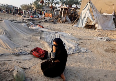 A Palestinian woman at the site of an Israeli strike on a tent camp sheltering displaced people at the Al-Mawasi area in Khan Younis in the southern Gaza Strip. Reuters