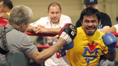 Philippine boxer Manny Pacquiao, right, trains at the Cotai Arena Gym of the Venetian Resort and Casino in Macau. Team Pacquiao, Mike Young / AP Photo