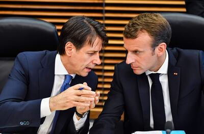 French President Emmanuel Macron (R) speaks with Italian Prime Minister Giuseppe Conte during a round table meeting at an informal EU summit on migration at EU headquarters in Brussels on June 24, 2018. AFP / Geert Vanden Wijngaert